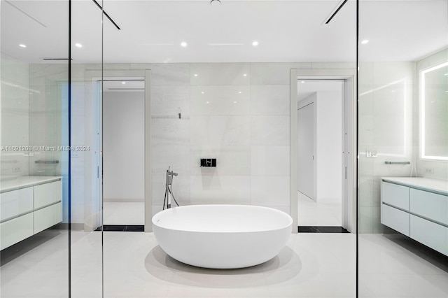 bathroom with walk in shower, vanity, and tile walls