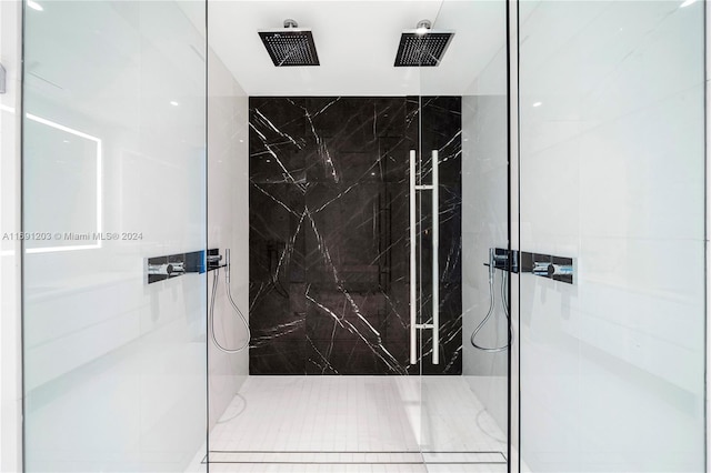 bathroom with tile patterned floors and a tile shower