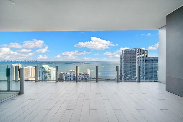 view of patio featuring a balcony and a water view