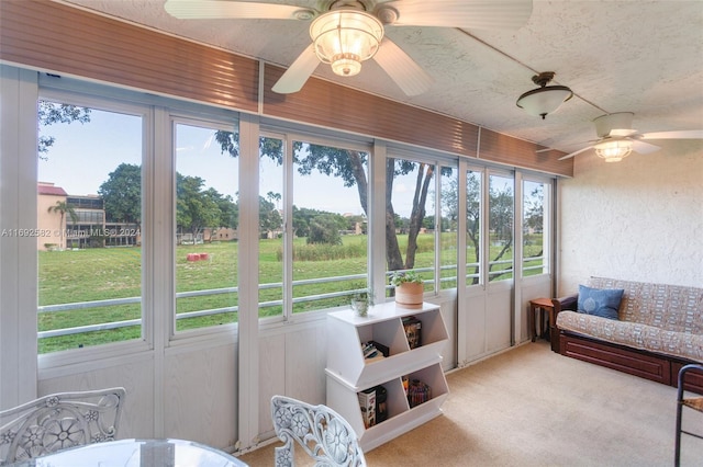 sunroom / solarium featuring ceiling fan