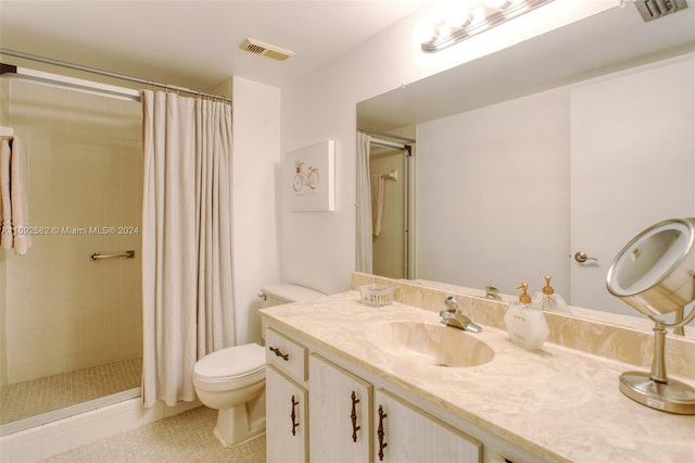 bathroom featuring toilet, vanity, a shower with shower curtain, and tile patterned flooring