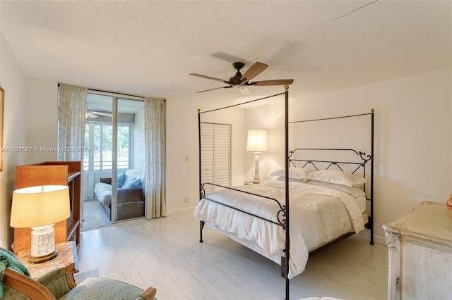 bedroom featuring a closet, a textured ceiling, access to exterior, ceiling fan, and light hardwood / wood-style flooring