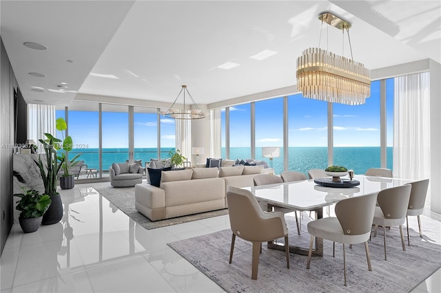 sunroom featuring a chandelier, a water view, and a healthy amount of sunlight