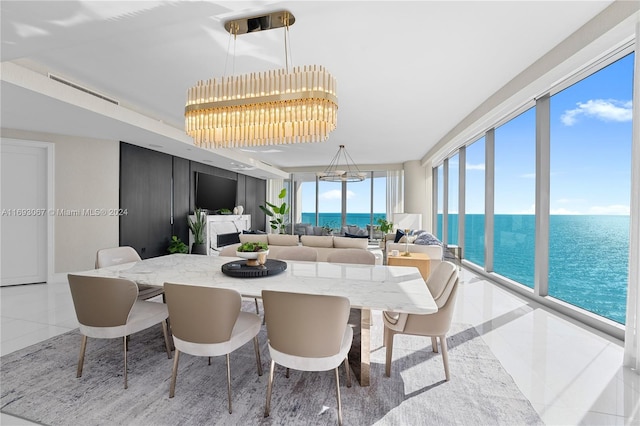 dining area featuring a chandelier and light tile patterned flooring