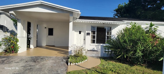 doorway to property with a carport