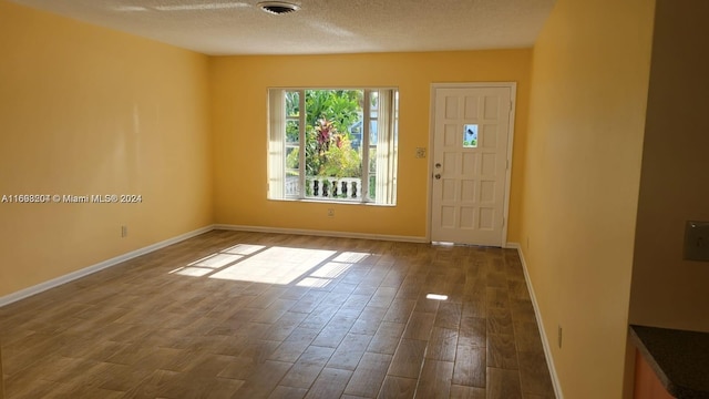 foyer entrance with a textured ceiling and hardwood / wood-style flooring