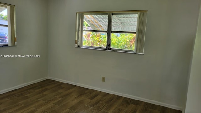 empty room with dark wood-type flooring