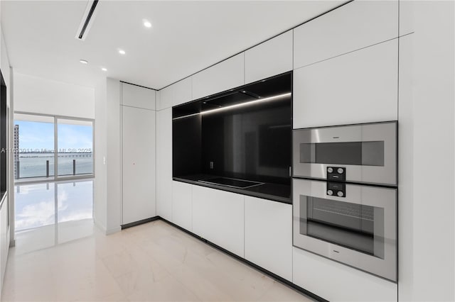 kitchen with double oven and white cabinets