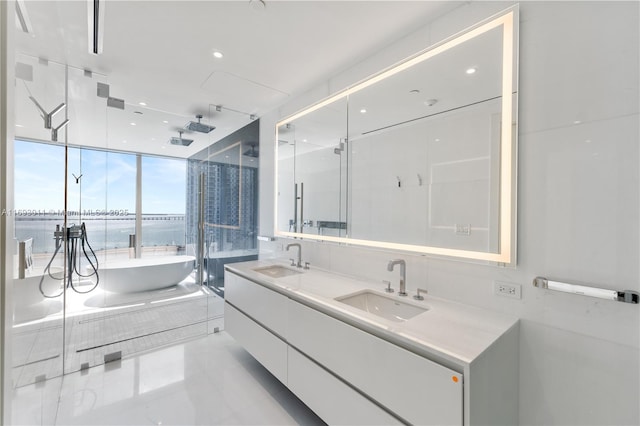 bathroom with plus walk in shower, tile patterned flooring, expansive windows, a water view, and vanity