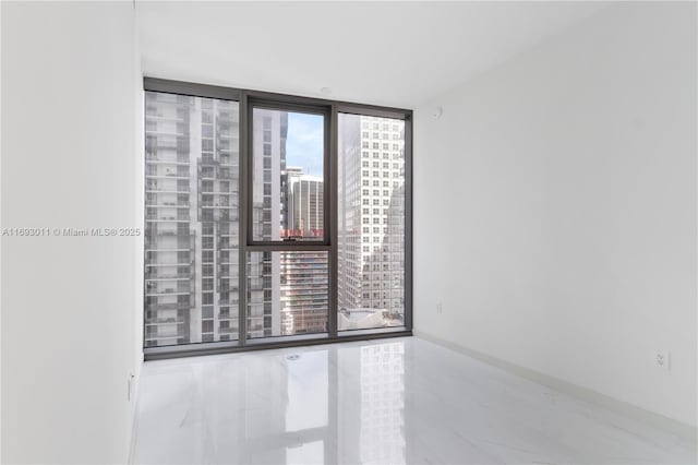 unfurnished room with tile patterned floors and floor to ceiling windows