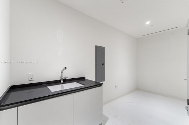 interior space featuring white cabinets and sink