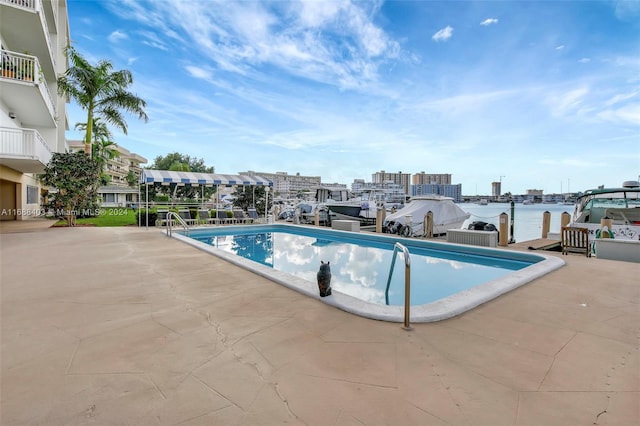 view of swimming pool with a water view