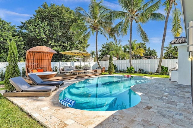 view of swimming pool featuring a patio and a wooden deck