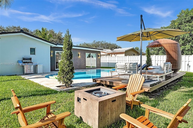 view of yard featuring a fenced in pool and a fire pit