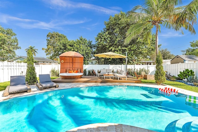 view of swimming pool with a wooden deck and an outdoor living space