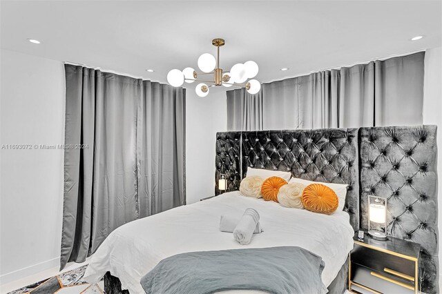 bedroom featuring an inviting chandelier