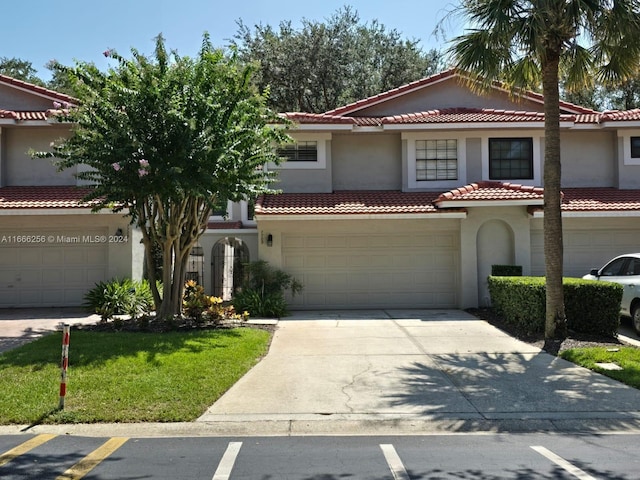 mediterranean / spanish-style house with a garage