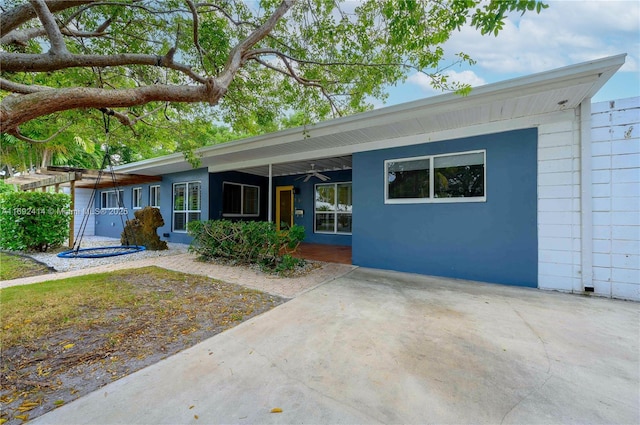 back of property with ceiling fan