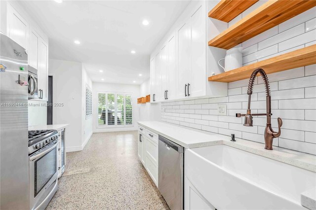 kitchen featuring white cabinets, appliances with stainless steel finishes, and sink