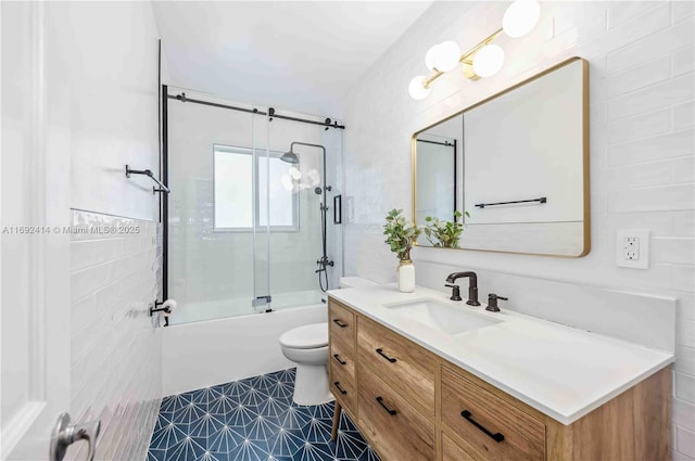 full bathroom with tile patterned floors, vanity, toilet, and enclosed tub / shower combo