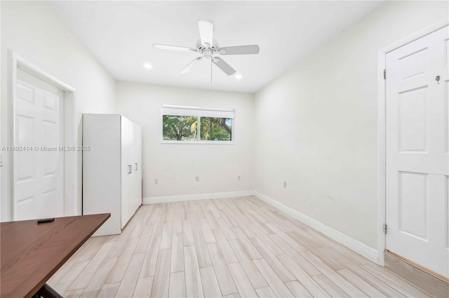 empty room featuring ceiling fan and light wood-type flooring