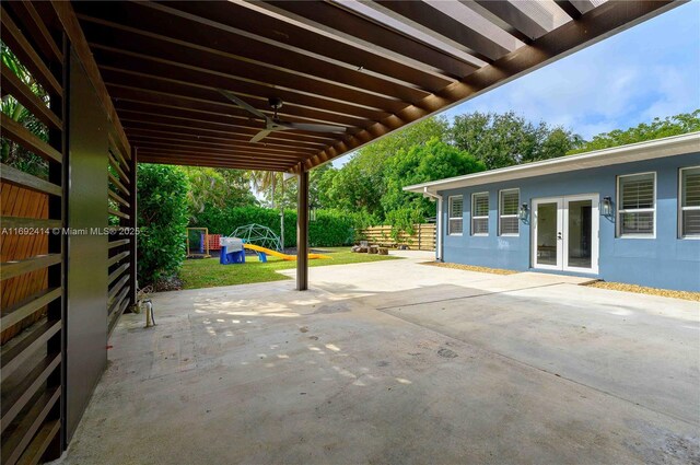 view of patio / terrace with ceiling fan, a playground, and french doors