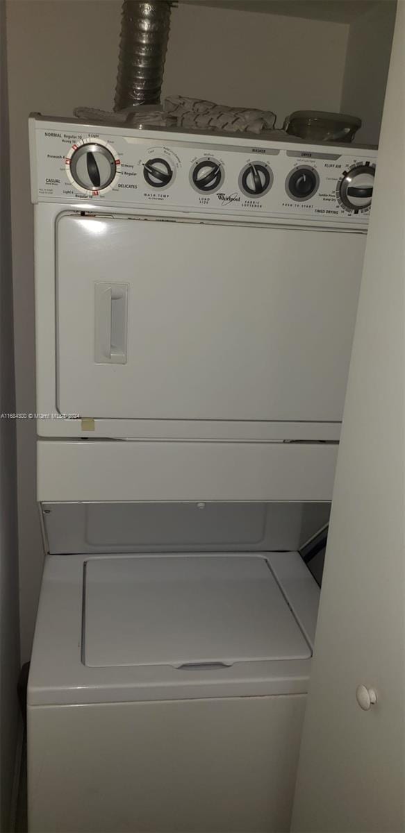 washroom with stacked washer and dryer