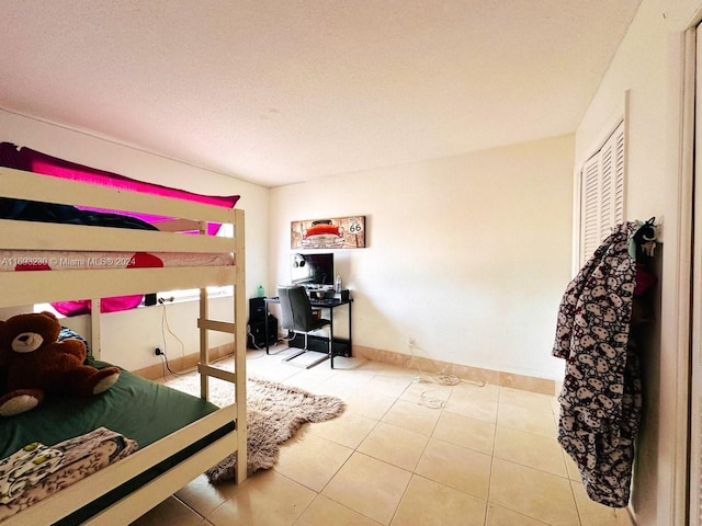 tiled bedroom with a textured ceiling