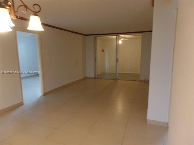 tiled empty room with ornamental molding