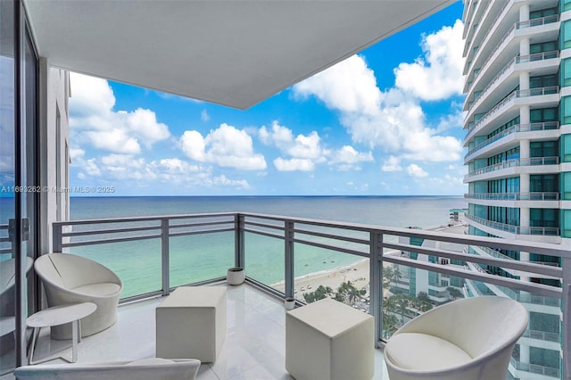 balcony featuring a water view and a view of the beach