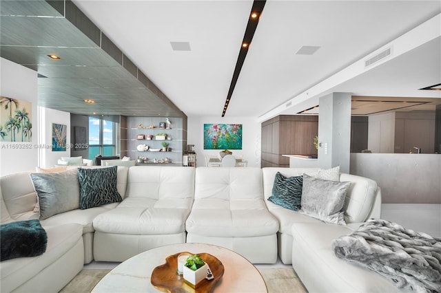 living room featuring a water view and visible vents