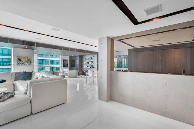 living room featuring light tile patterned floors and visible vents