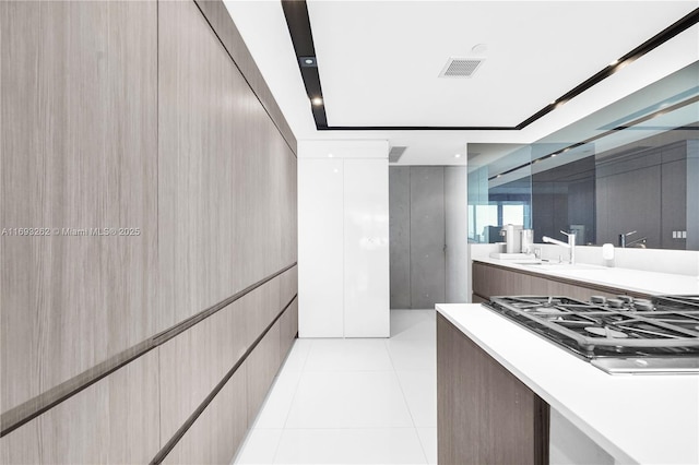 interior space featuring tile patterned flooring, visible vents, and vanity