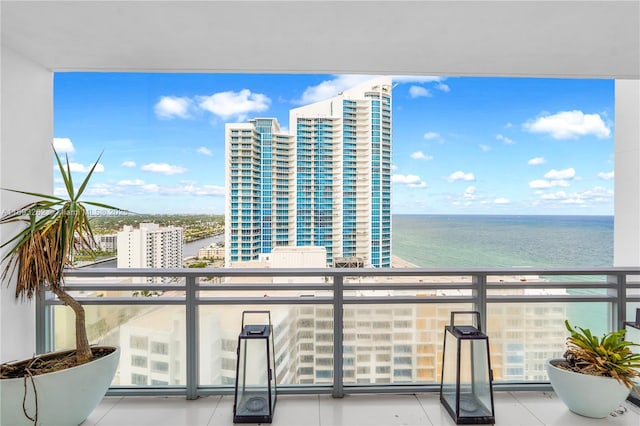 balcony featuring a view of city and a water view