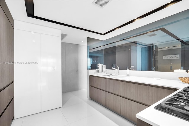 bathroom with tile patterned flooring, visible vents, and vanity