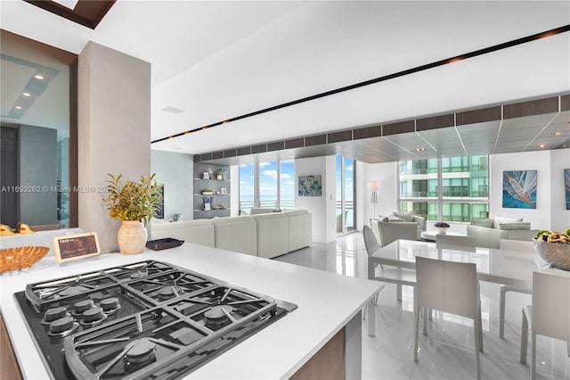 kitchen with open floor plan, light countertops, and stovetop