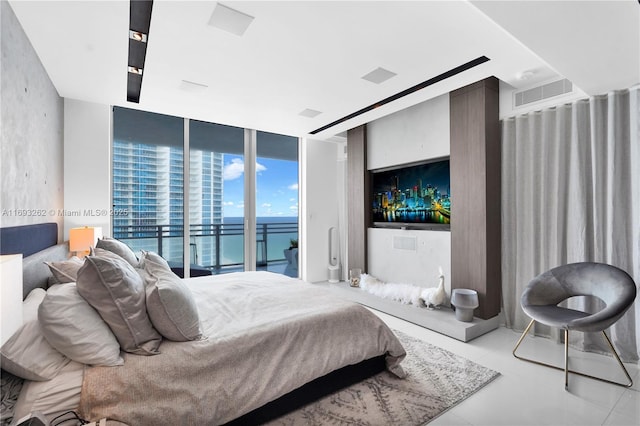 bedroom featuring access to exterior, visible vents, and floor to ceiling windows