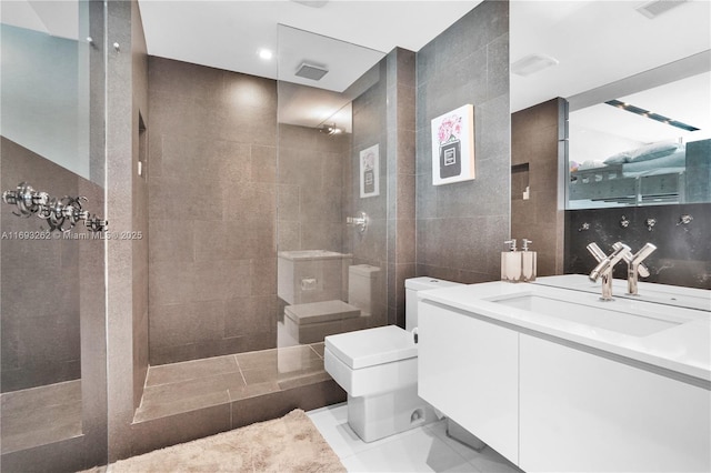 bathroom featuring toilet, tile walls, vanity, and walk in shower