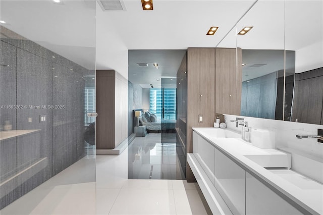 ensuite bathroom with double vanity, visible vents, a sink, and ensuite bathroom