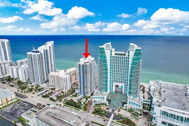 birds eye view of property featuring a water view and a city view