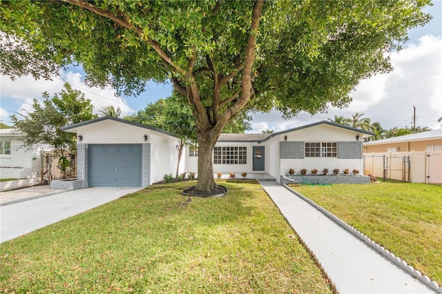 ranch-style house featuring a front lawn and a garage