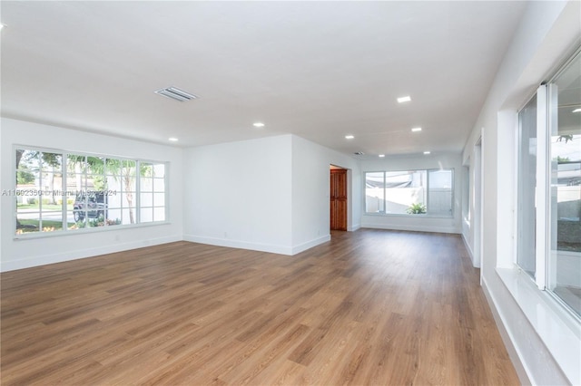 empty room with light hardwood / wood-style flooring