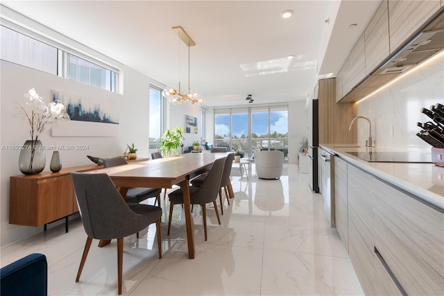 dining area with a notable chandelier and sink