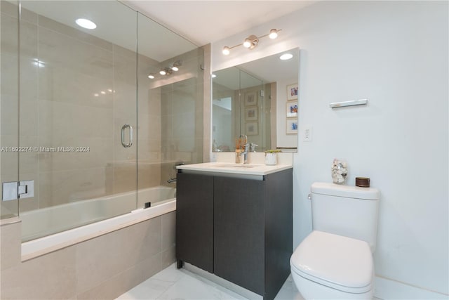 full bathroom featuring enclosed tub / shower combo, vanity, and toilet