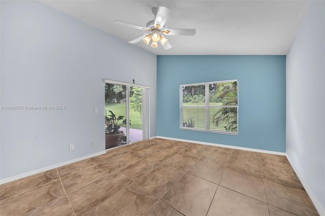 empty room featuring tile patterned floors, ceiling fan, and lofted ceiling