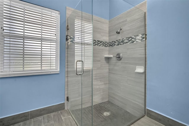 bathroom featuring hardwood / wood-style floors and walk in shower