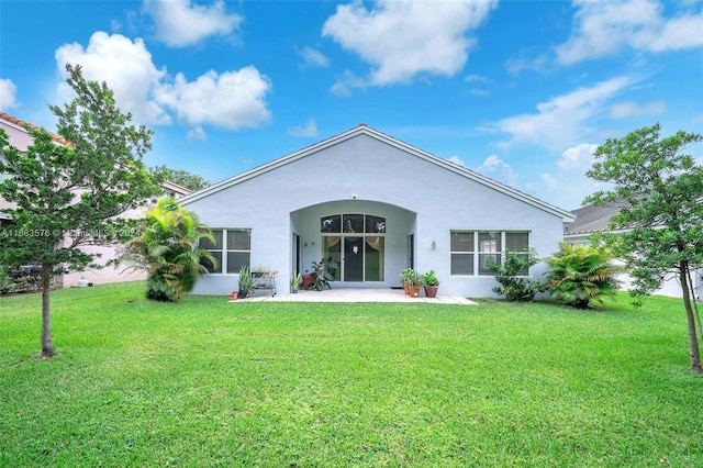 rear view of house with a yard