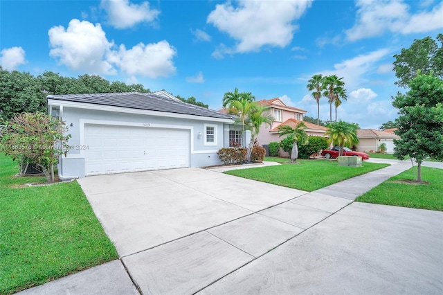 ranch-style home featuring a front lawn and a garage