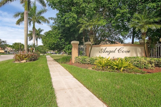 community / neighborhood sign with a lawn