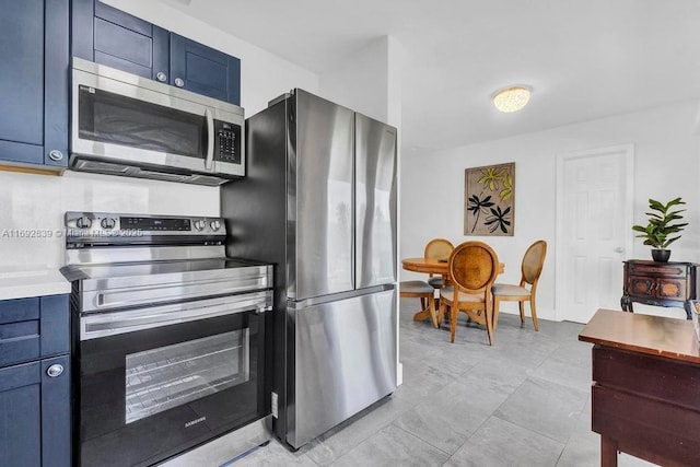 kitchen featuring appliances with stainless steel finishes and blue cabinetry